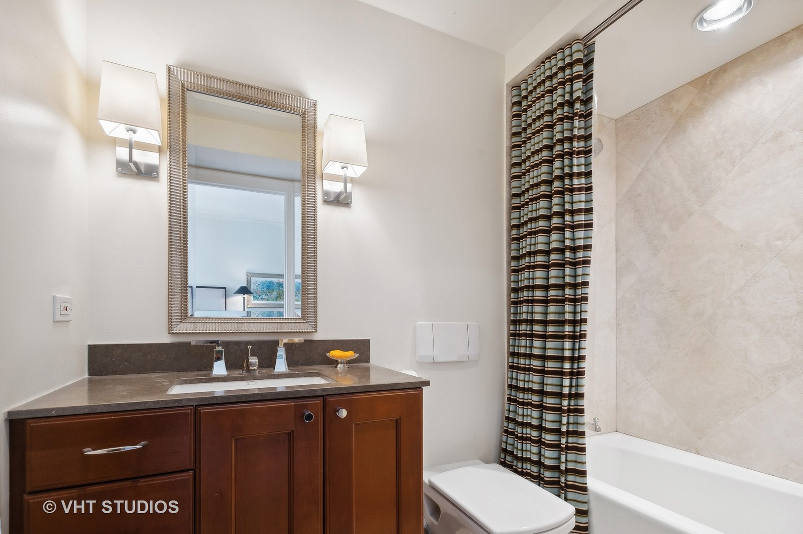 800 North Michigan Avenue, Unit 4702 Chicago, IL 60611 - Photo 24 of 31 a bathroom with a sink a toilet a shower and a mirror