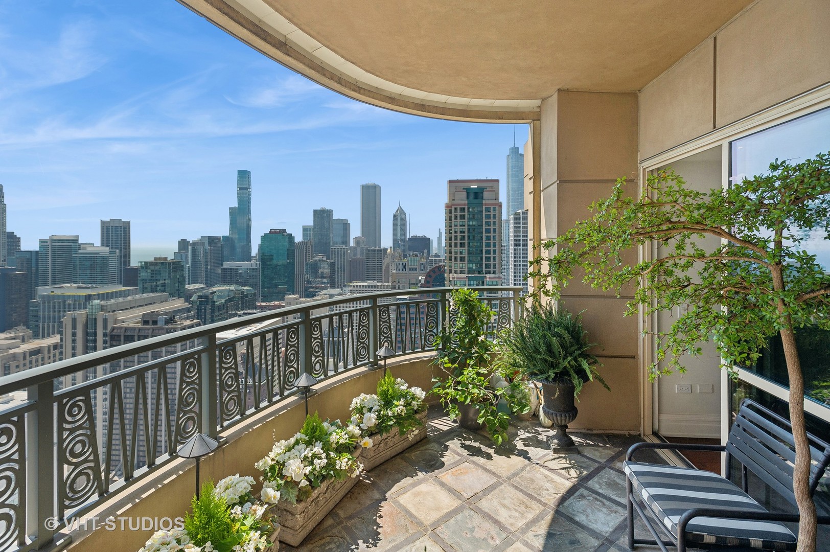 800 North Michigan Avenue, Unit 4702 Chicago, IL 60611 - Photo 6 of 31 a view of a balcony with wooden chairs