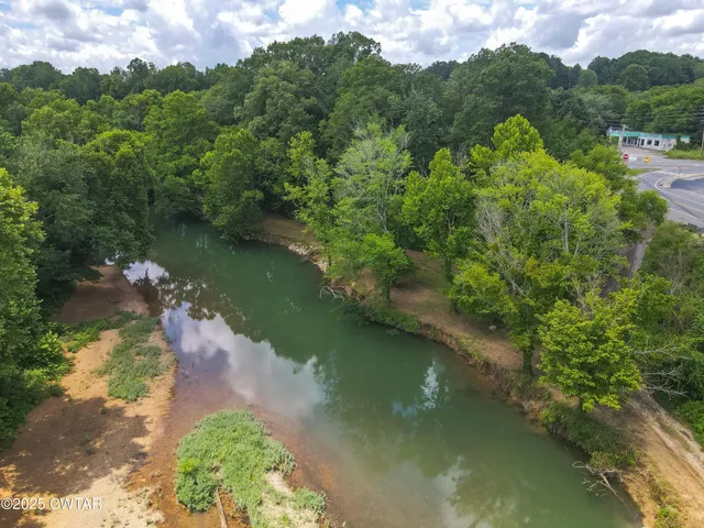 an aerial view of a houses with a yard