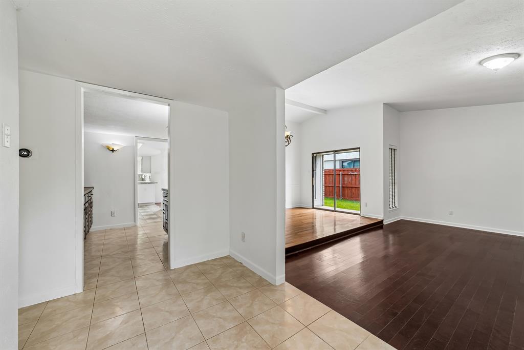 10239 Green Ash Road Dallas, TX 75243 - Photo 2 of 36 Bright interior featuring a combination of tiled flooring and dark wood-finish flooring