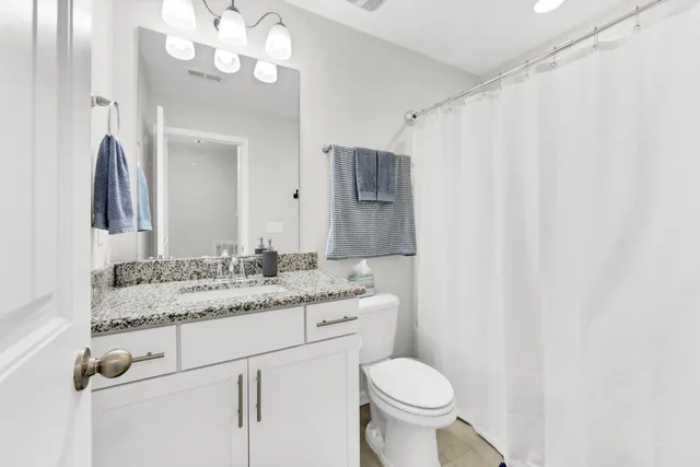 an empty room with windows and ceiling fan