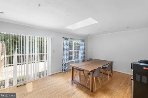 a living room with furniture a bed and a large window