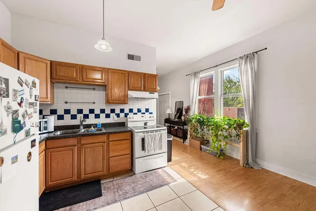 a kitchen with a sink window and cabinets