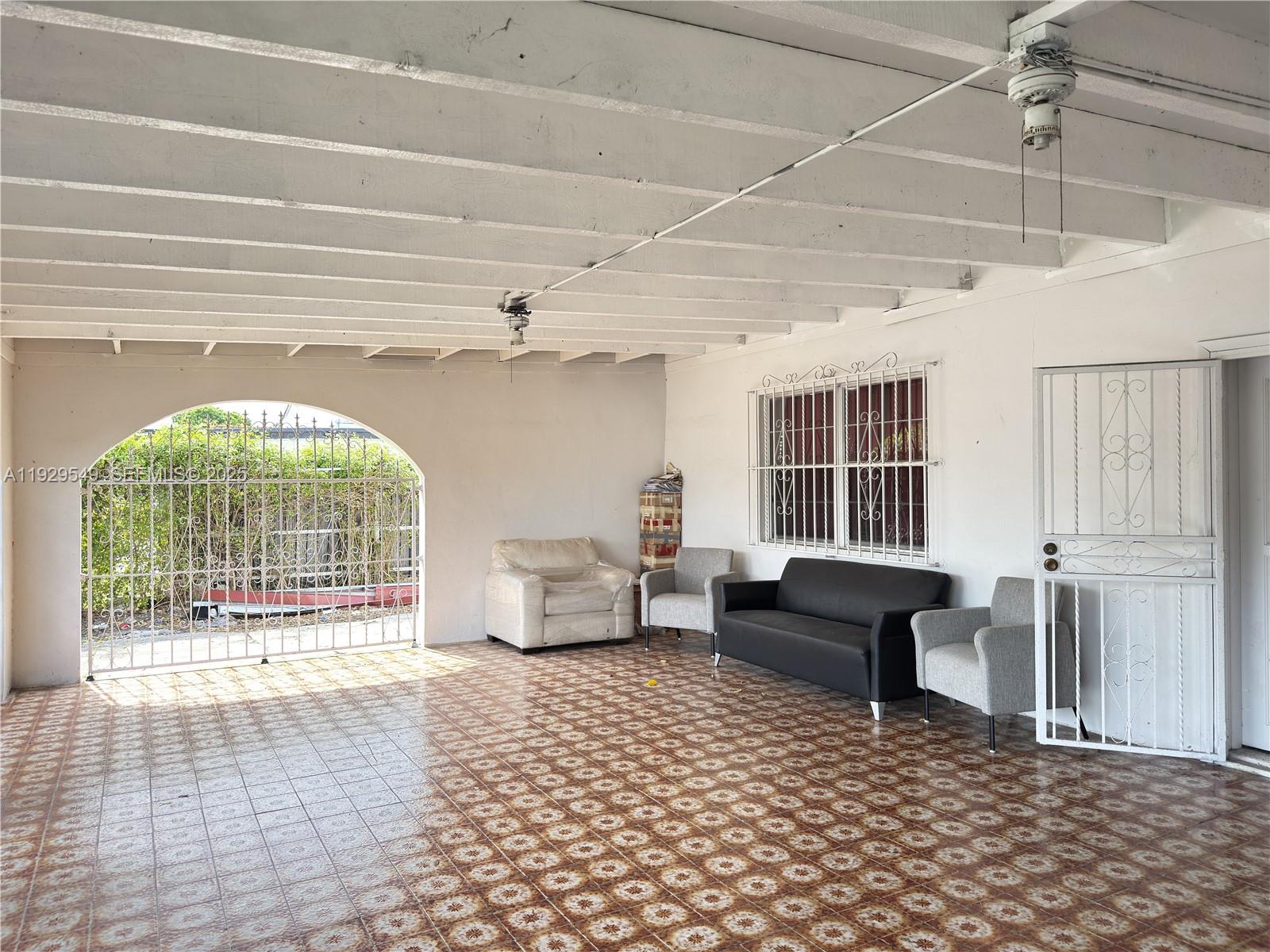 343 West 42nd Street, Unit A Hialeah, FL 33012 - Photo 6 of 13 a living room with furniture and a table