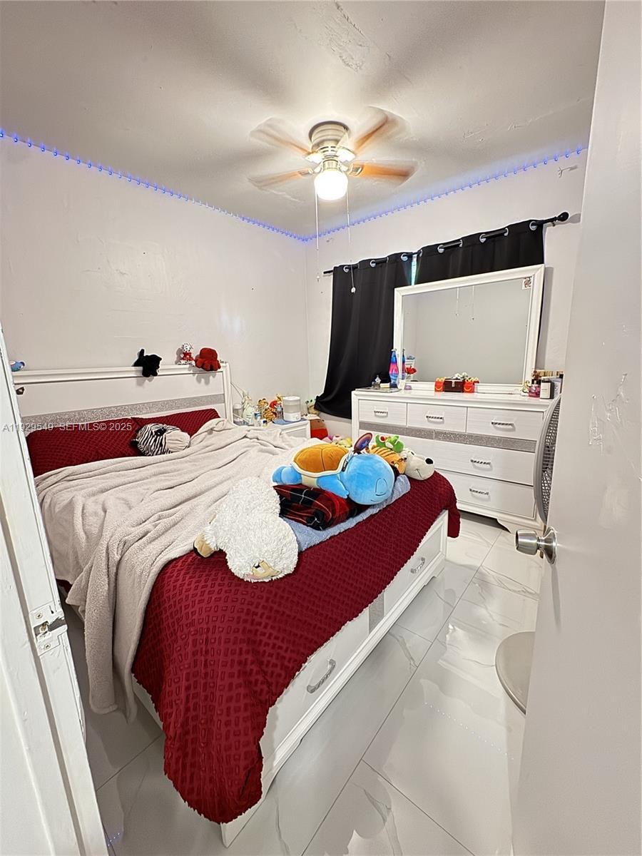 343 West 42nd Street, Unit A Hialeah, FL 33012 - Photo 9 of 13 a bedroom with a bed and window