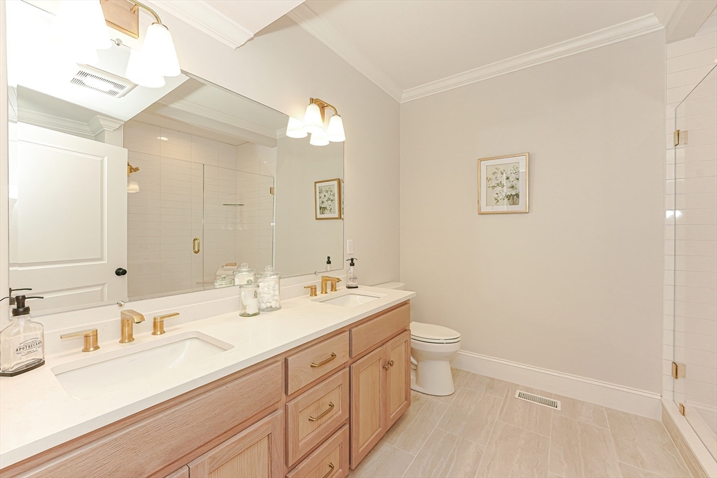 3 Damon Road, Unit 12 Needham Heights, MA 02494 - Photo 11 of 16 a bathroom with a double vanity sink mirror and toilet