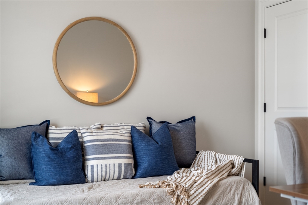 3 Damon Road, Unit 12 Needham Heights, MA 02494 - Photo 12 of 16 a bed with a bed and a mirror