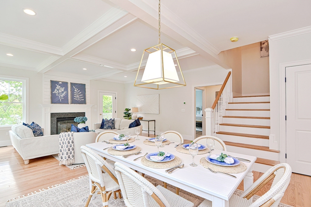 3 Damon Road, Unit 12 Needham Heights, MA 02494 - Photo 8 of 16 a dining room with furniture a fireplace and wooden floor