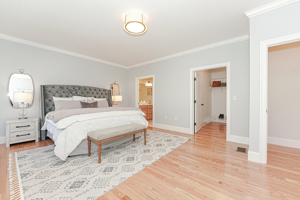3 Damon Road, Unit 12 Needham Heights, MA 02494 - Photo 9 of 16 a bedroom with a bed and wooden floor