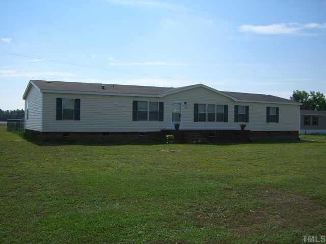 82 North Spring Branch Road Dunn, NC 28334 - Photo 1 of 2 a front view of a house with a garden