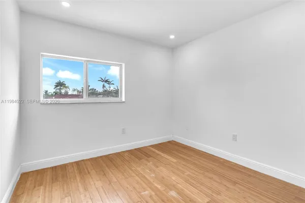 a view of room with wooden floor and window