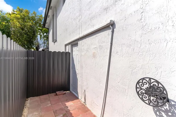 an aerial view of a city with lots of residential buildings and mountain view in back