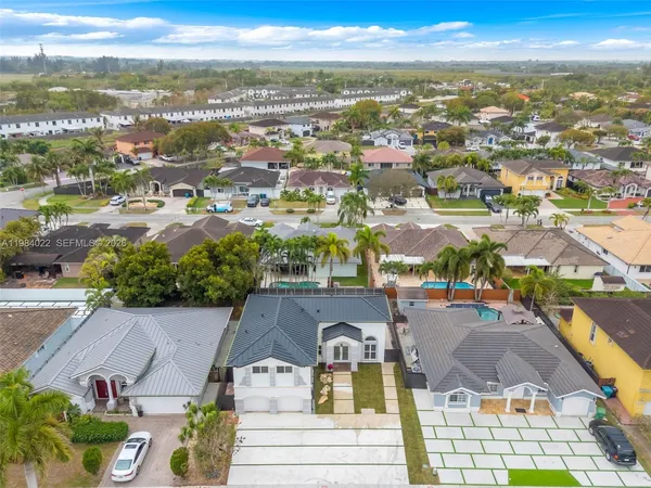an aerial view of residential houses with outdoor space