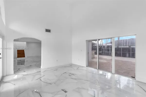 an empty room with a empty space and windows