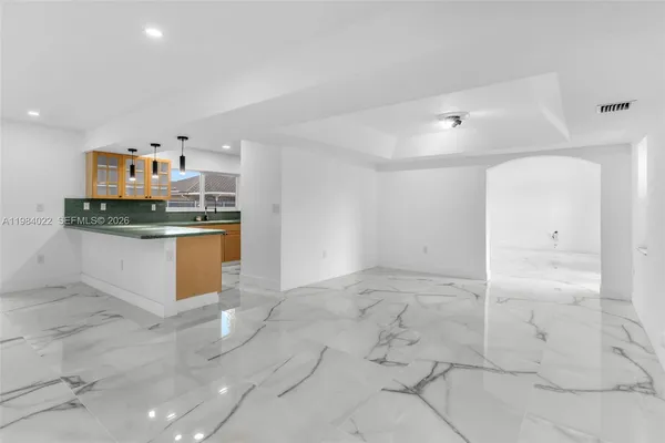 a view of a kitchen with a sink and cabinets