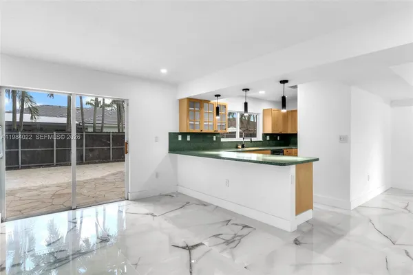 a kitchen with stainless steel appliances granite countertop a sink a stove and a refrigerator