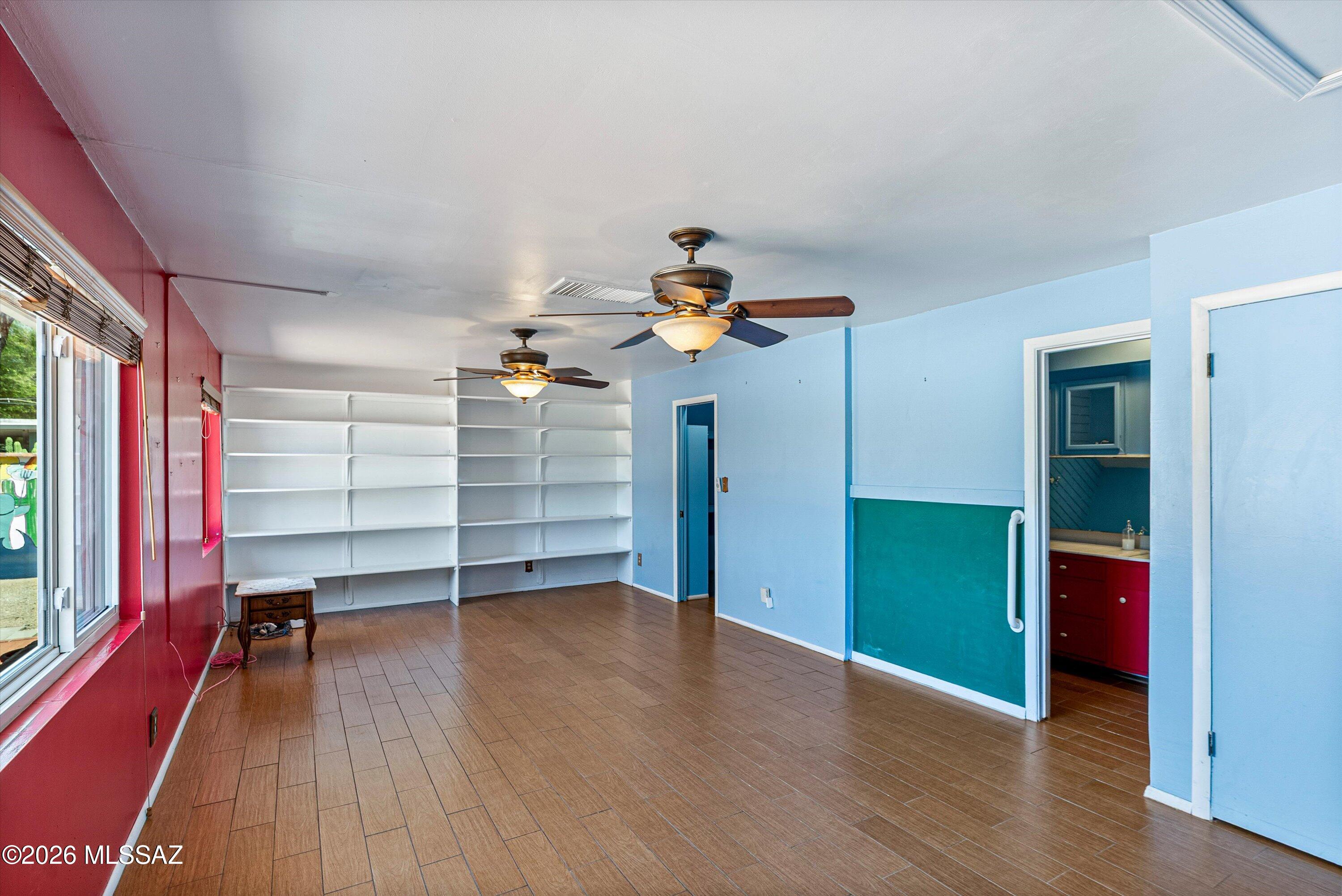 2107 East Lind Road Tucson, AZ 85719 - Photo 19 of 43 a view of a room with wooden floor closet and windows