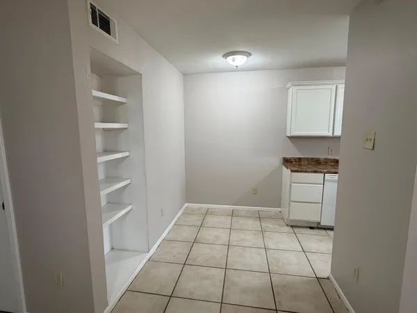 a room with a cabinets and a stove top oven