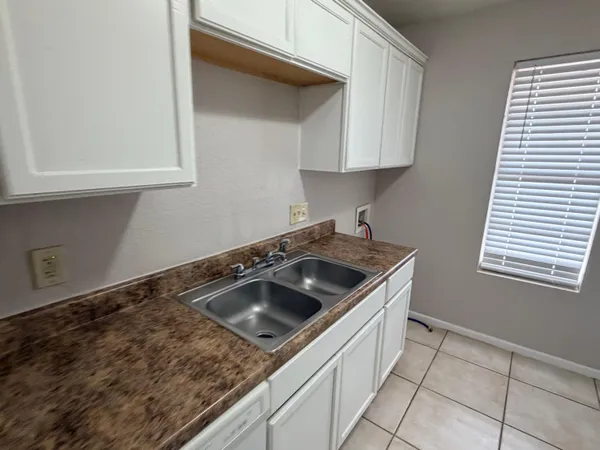 a kitchen that has a sink and a stove