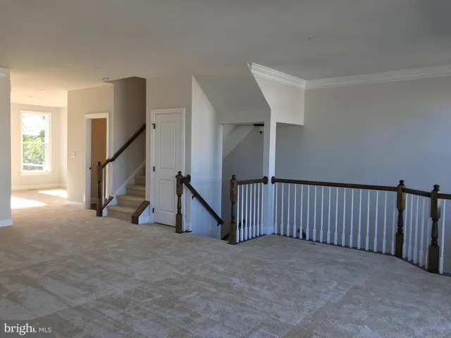a view of an empty room with stairs