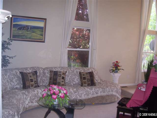 4890 West Creek Ridge Trail Reno, NV 89519 - Photo 4 of 9 a living room with furniture and flowers