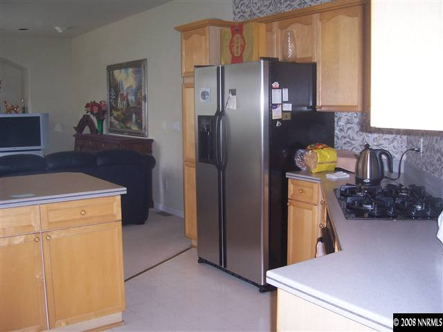 4890 West Creek Ridge Trail Reno, NV 89519 - Photo 5 of 9 a kitchen with stainless steel appliances a refrigerator and a stove