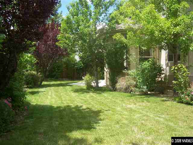 4890 West Creek Ridge Trail Reno, NV 89519 - Photo 8 of 9 a view of a backyard with large trees