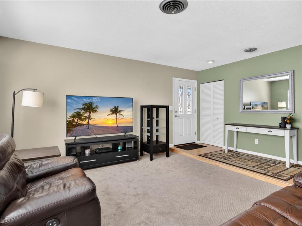 2803 Banchory Road Winter Park, FL 32792 - Photo 5 of 31 a living room with furniture and a flat screen tv