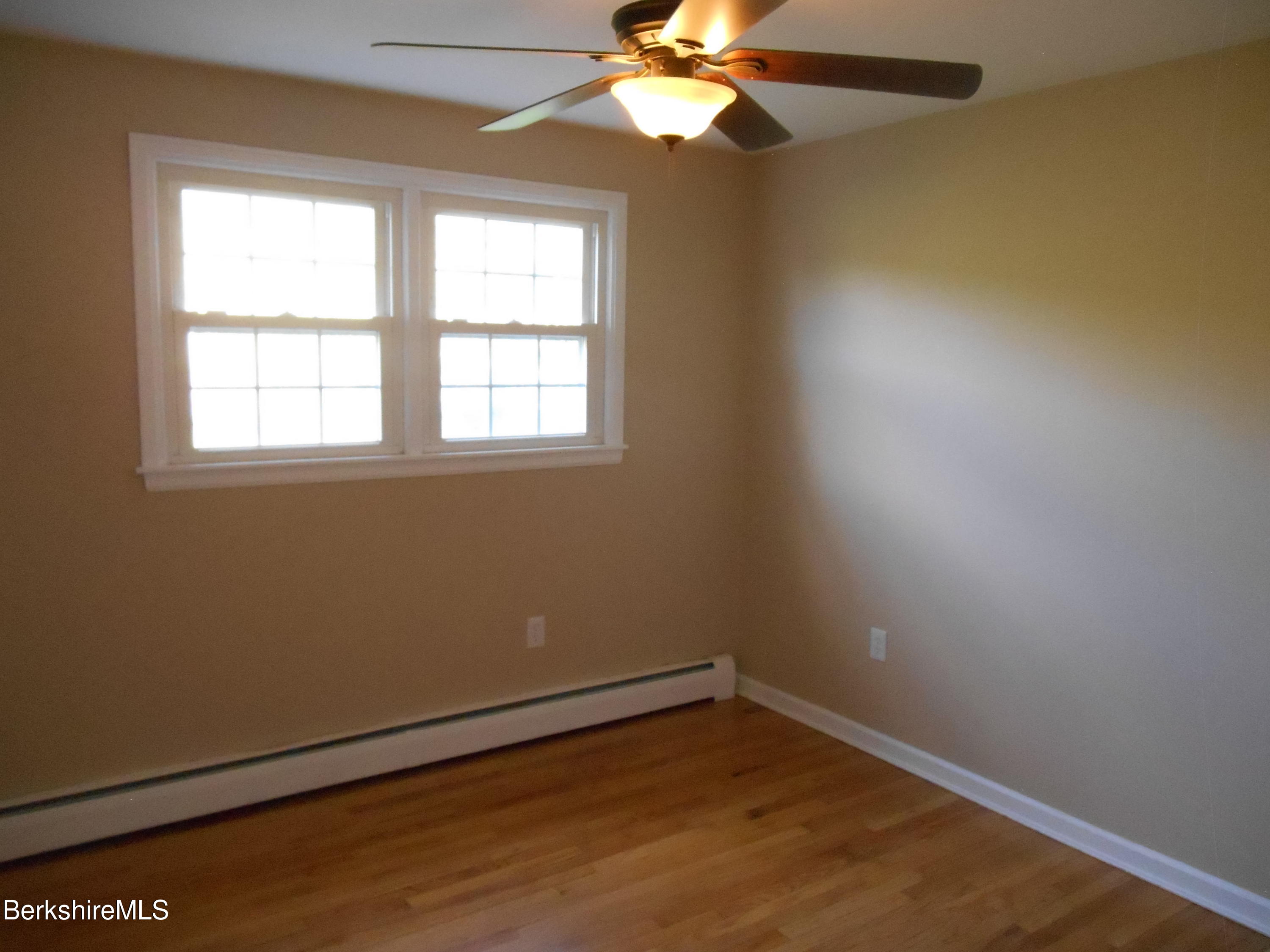 238 Swamp Road Richmond, MA 01201 - Photo 11 of 21 an empty room with a window and a fan