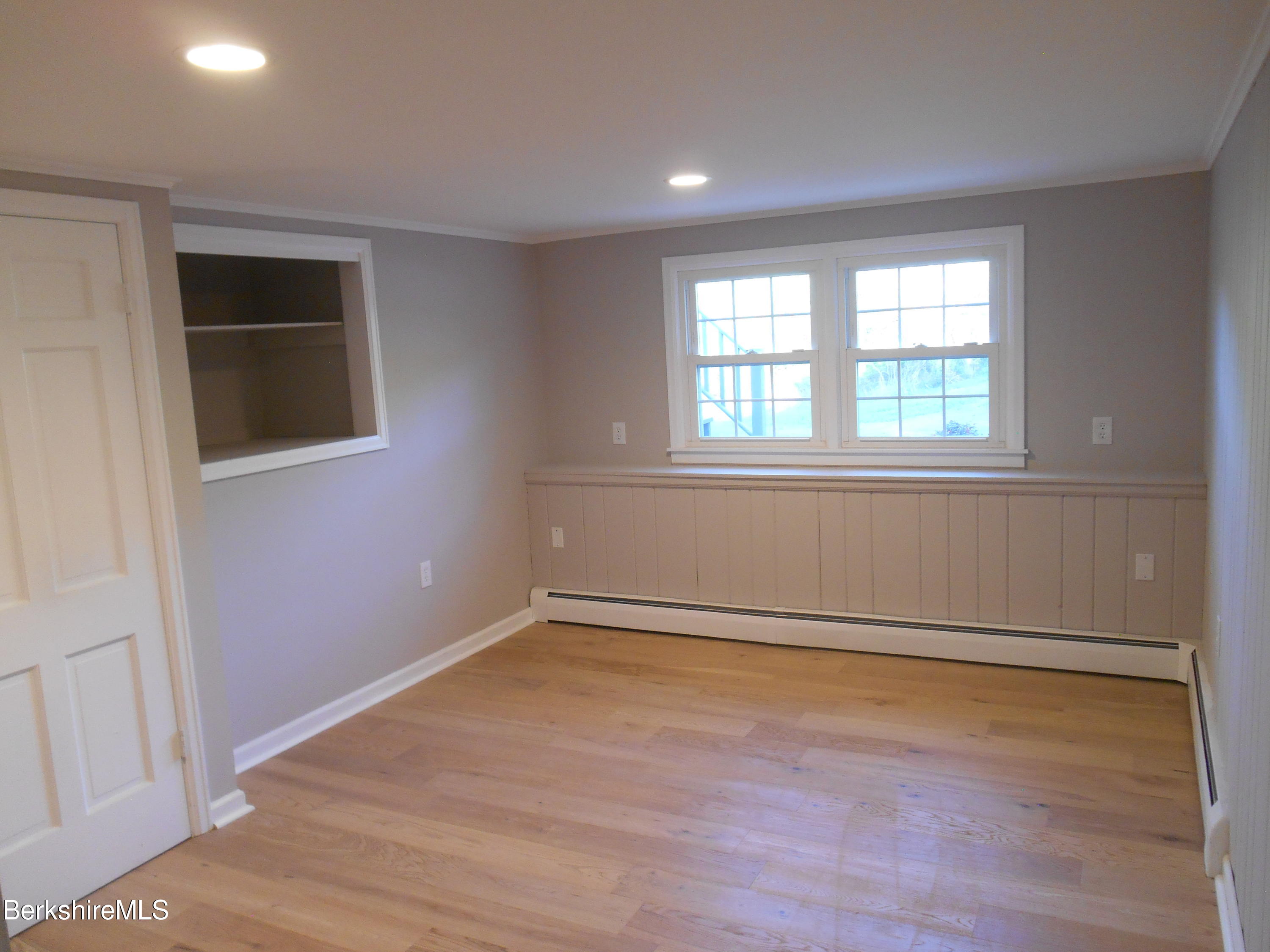 238 Swamp Road Richmond, MA 01201 - Photo 16 of 21 an empty room with wooden floor and windows