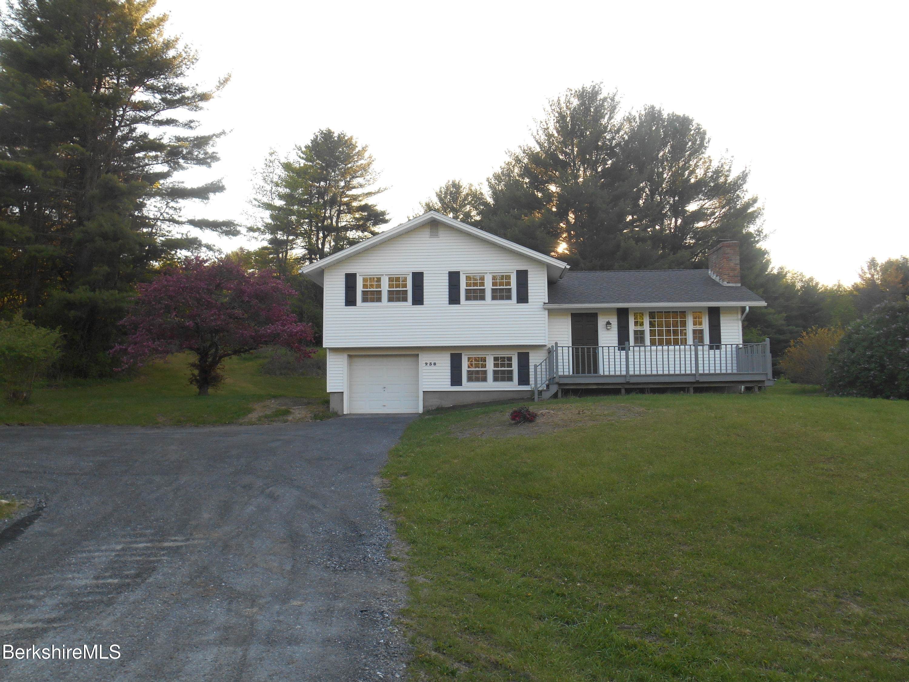 238 Swamp Road Richmond, MA 01201 - Photo 3 of 21 a front view of a house with a garden