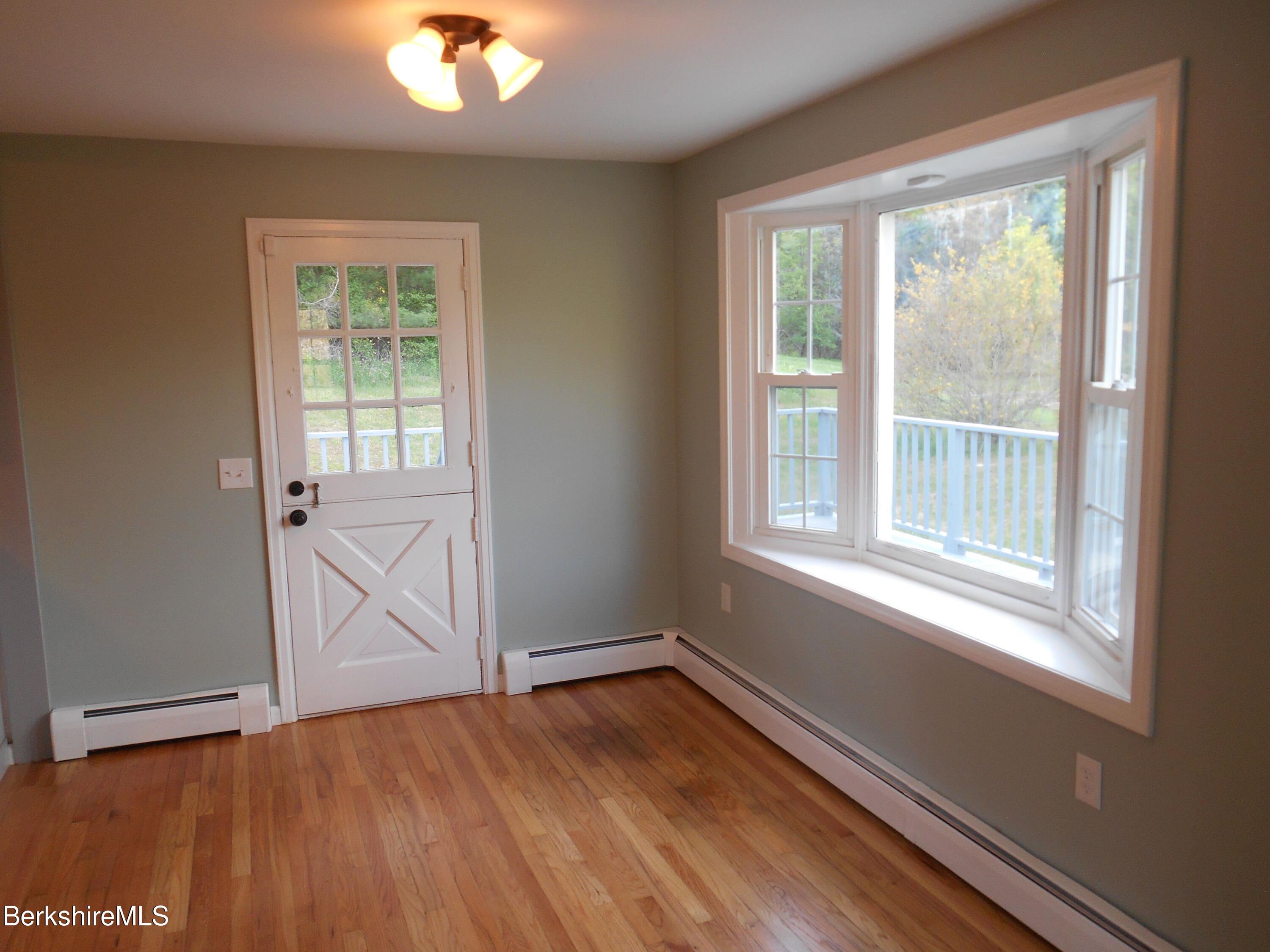 238 Swamp Road Richmond, MA 01201 - Photo 8 of 21 an empty room with wooden floor and windows