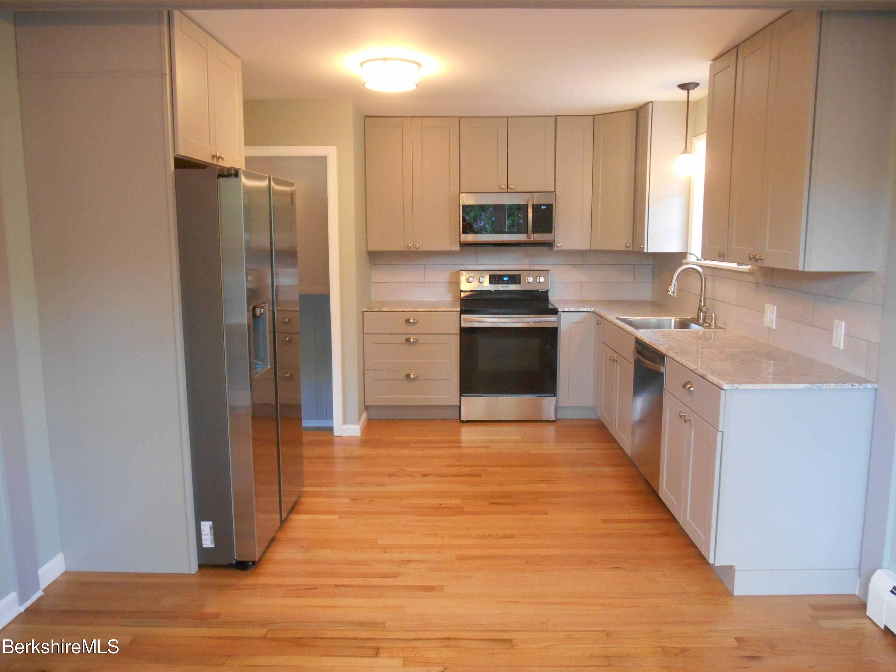238 Swamp Road Richmond, MA 01201 - Photo 9 of 21 a large kitchen with stainless steel appliances granite countertop a refrigerator stove and sink