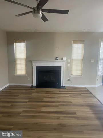 a view of empty room with a fireplace and window