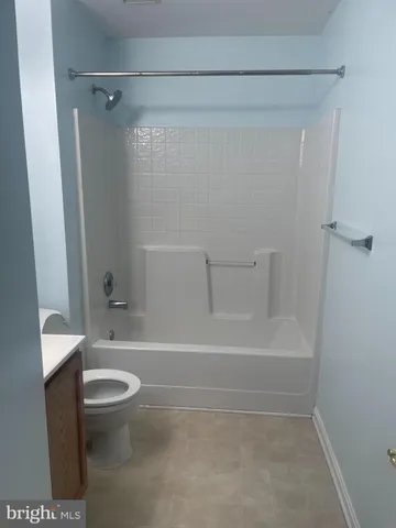 a bathroom with a toilet and a bath tub