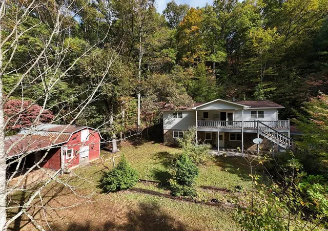 an aerial view of a house with a yard