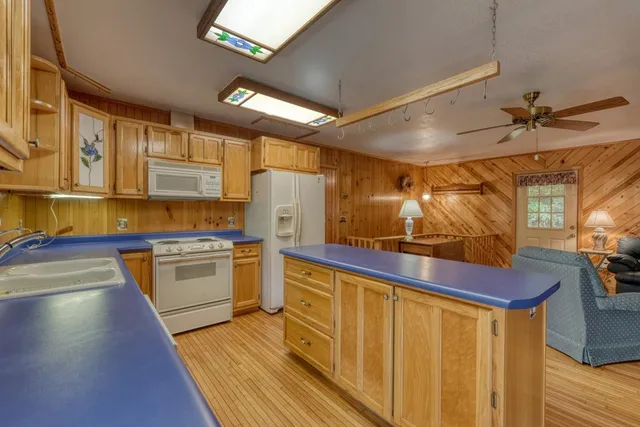 a kitchen with cabinets and wooden floor