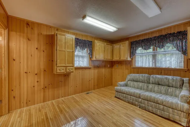 a living room with a couch and a wooden floor