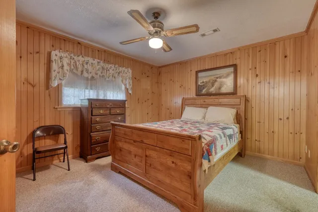 a bedroom with a bed and a desk