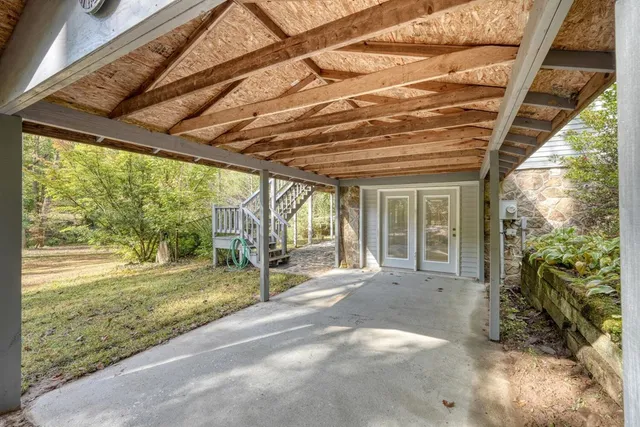 a view of balcony with wooden floor and outdoor seating