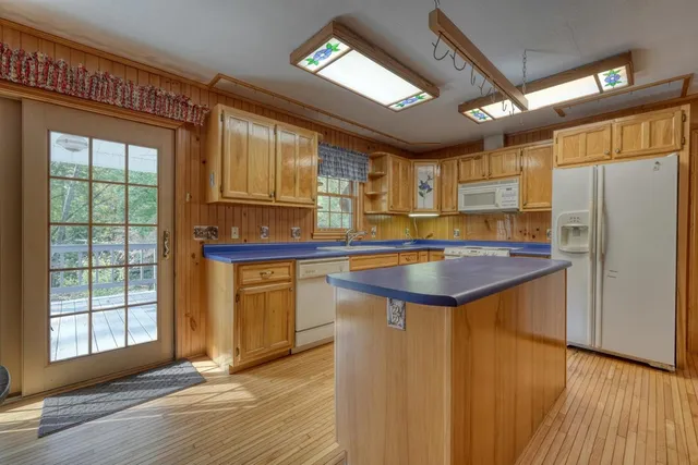 a kitchen with stainless steel appliances granite countertop a refrigerator a sink and a stove