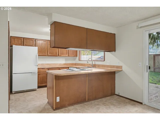 a view of an empty room with a fireplace