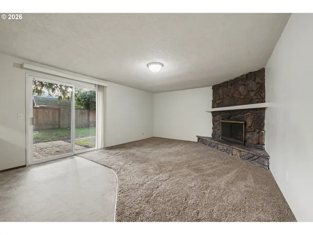 a view of an empty room with a fireplace