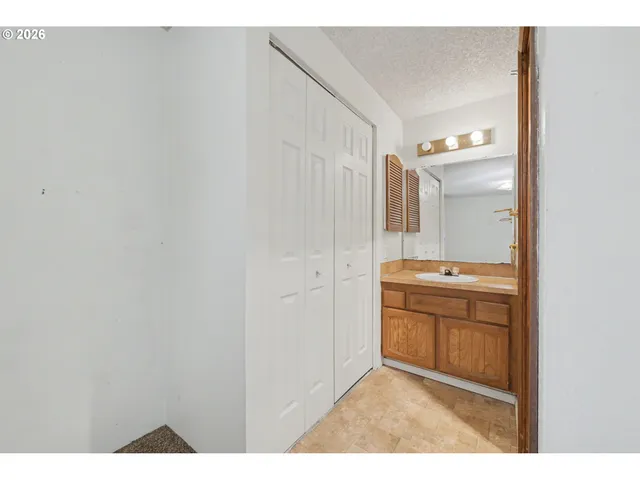 a bathroom with a sink a mirror and a shower