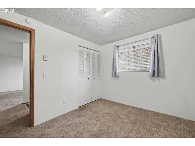 a view of a livingroom with an empty space and a window