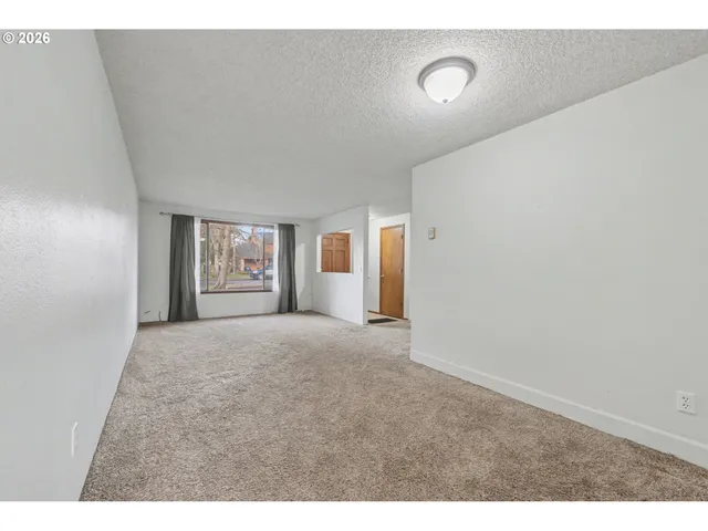 a view of an empty room with windows