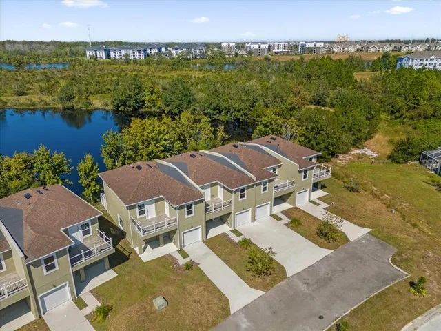 an aerial view of a house with a lake view