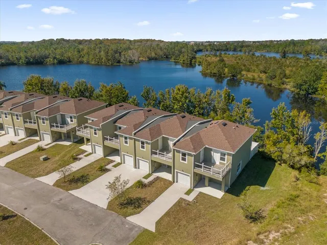 an aerial view of a house with outdoor space and lake view