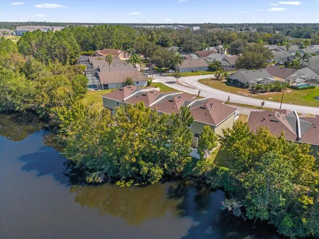 an aerial view of a house with garden space and lake view