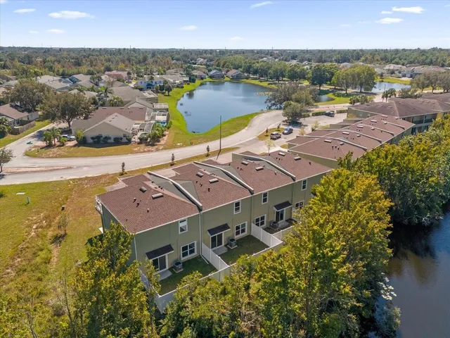 an aerial view of residential houses with outdoor space